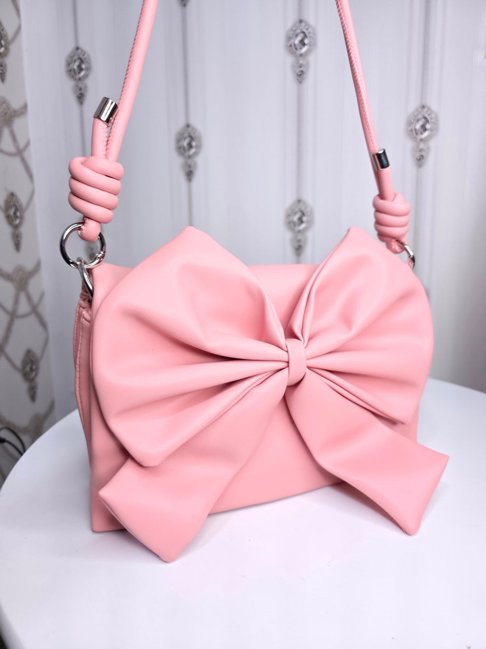 Soft leather peach bow bag with detachable sling