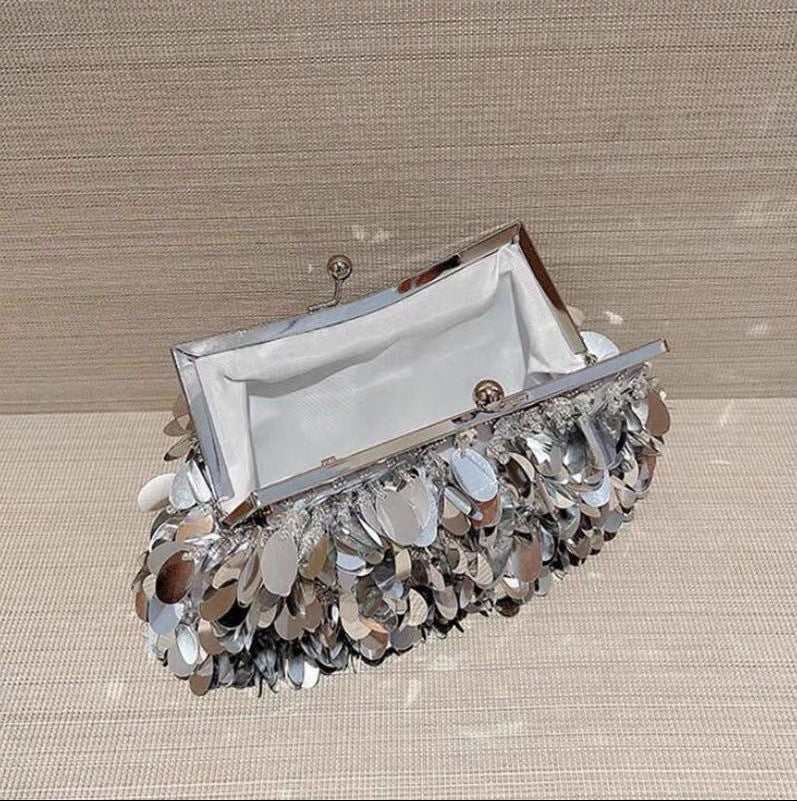 Collection of handbags with floral and crystal designs on a neutral background