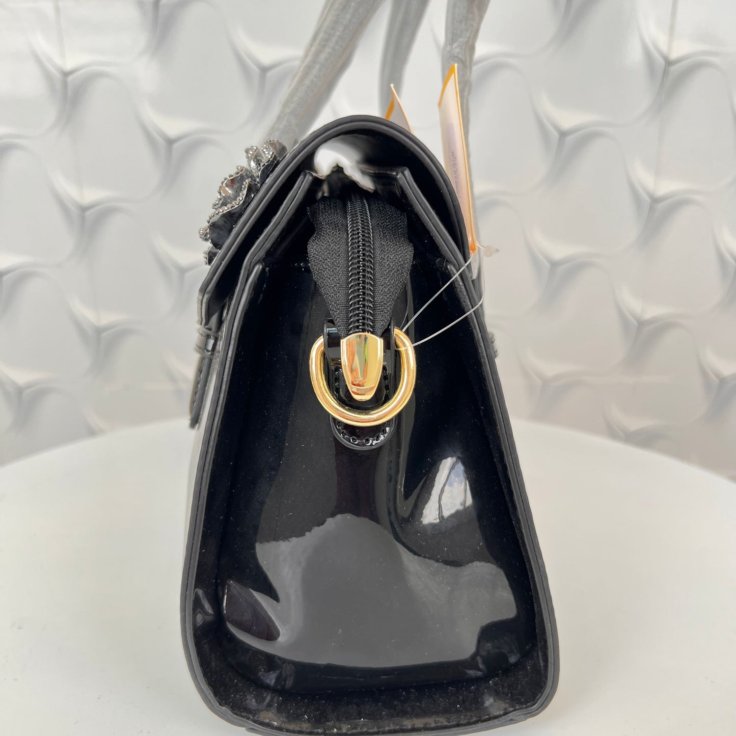 Designer shining leather handbag with stonework