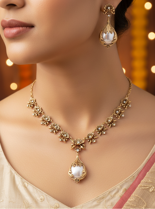 Gold necklace and earrings with white stones on a dark background, bgmates