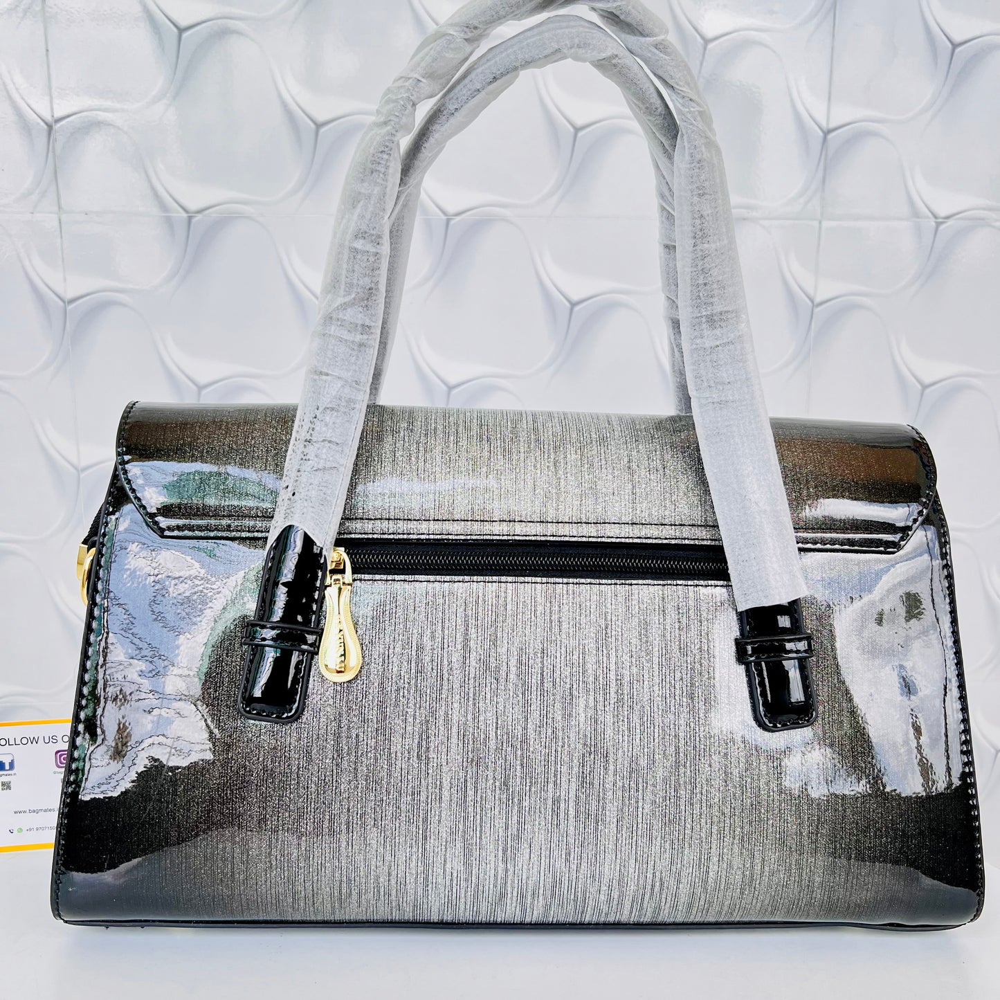Designer shining leather handbag with stonework