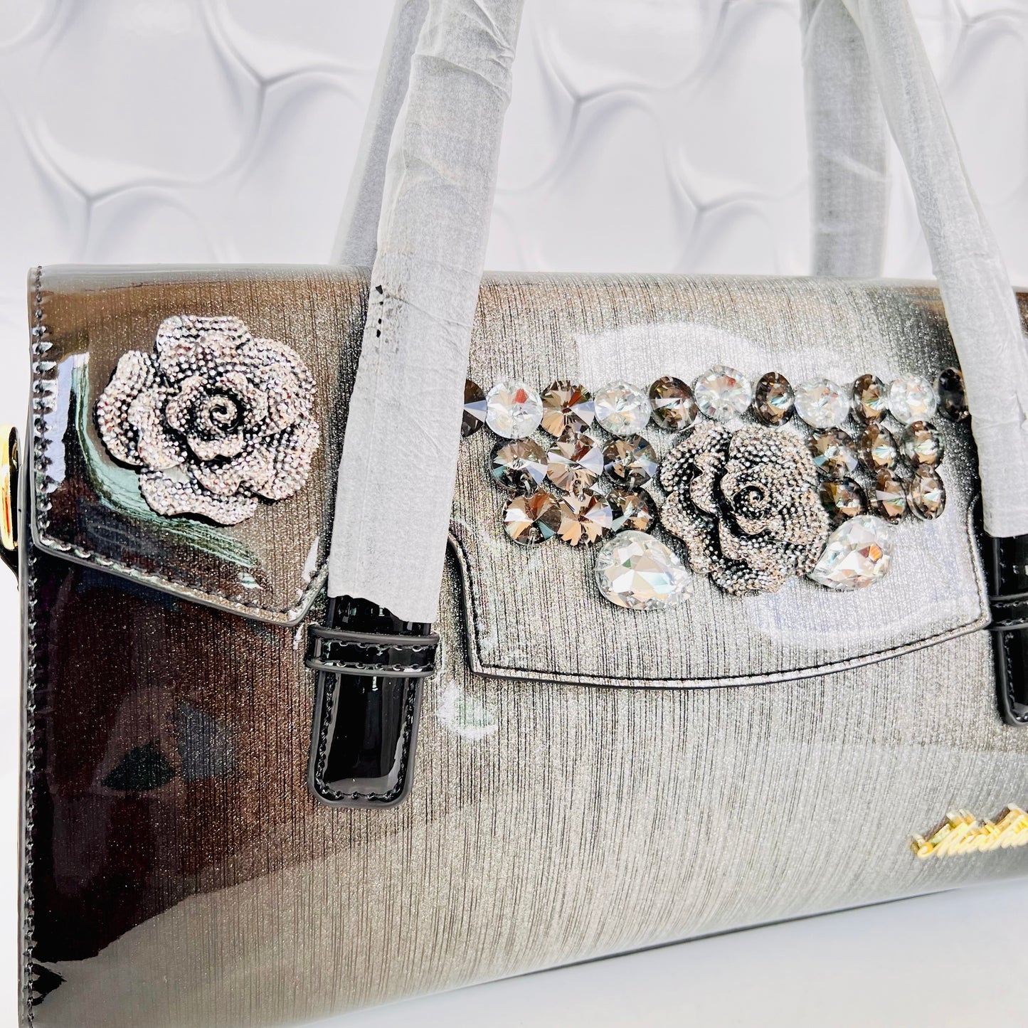 Designer shining leather handbag with stonework