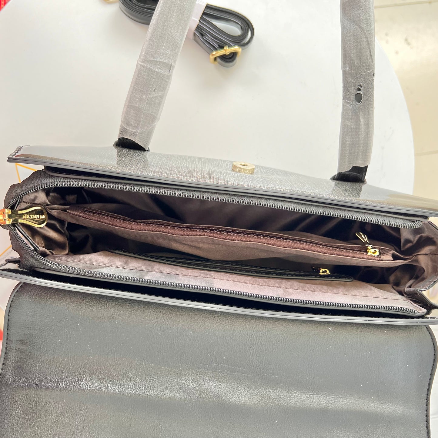 Designer shining leather handbag with stonework