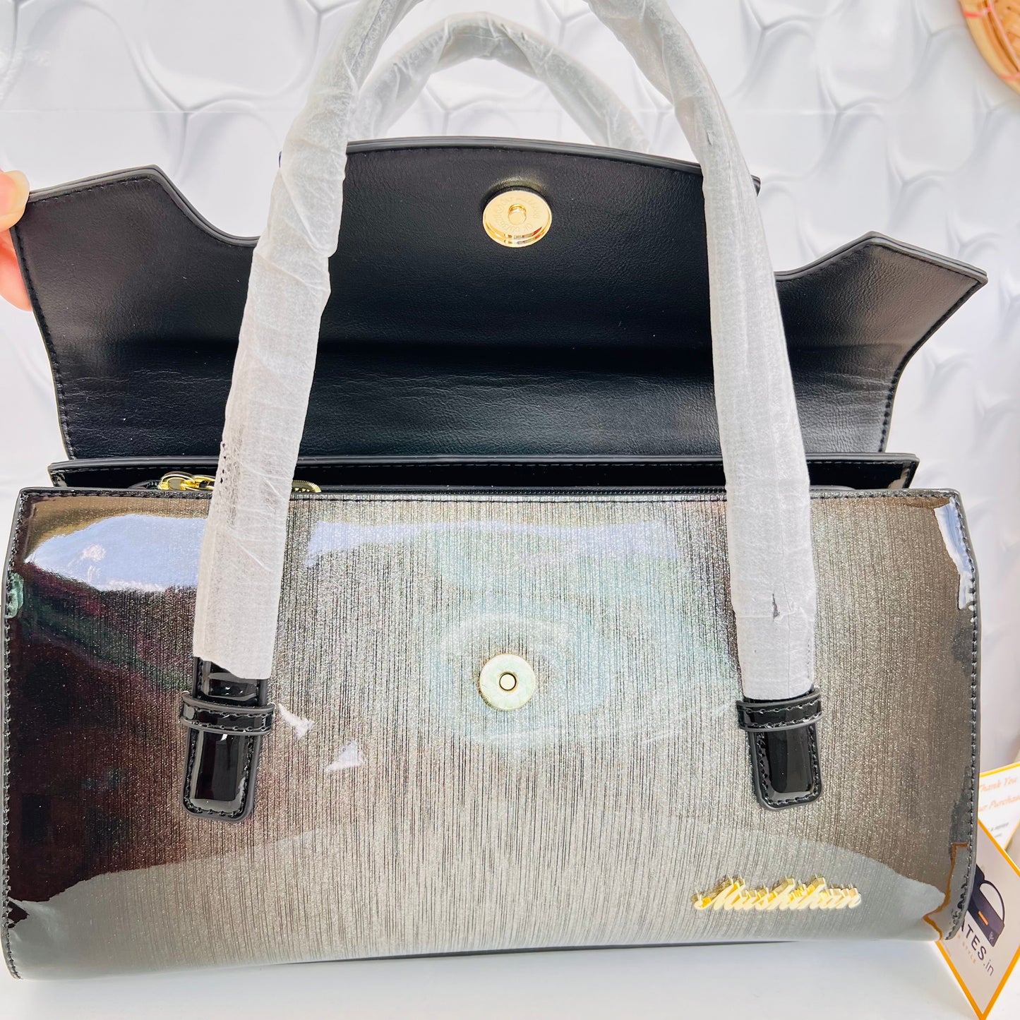 Designer shining leather handbag with stonework
