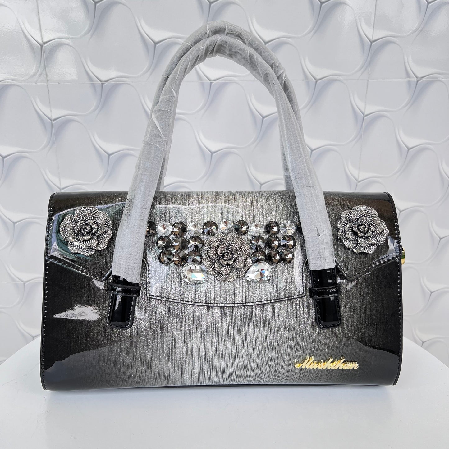 Designer shining leather handbag with stonework