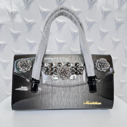 Designer shining leather handbag with stonework