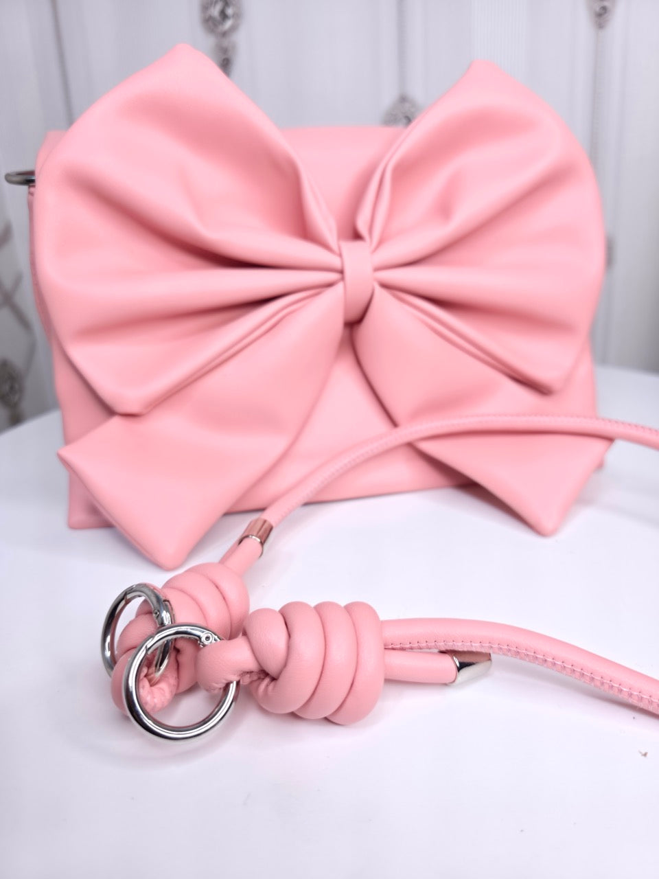 Soft leather peach bow bag with detachable sling