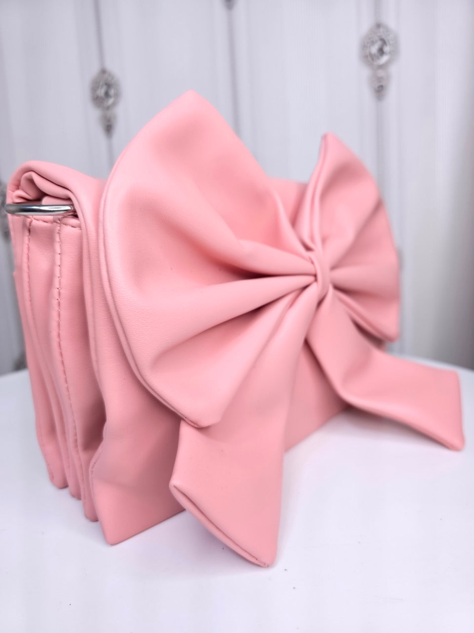 Soft leather peach bow bag with detachable sling