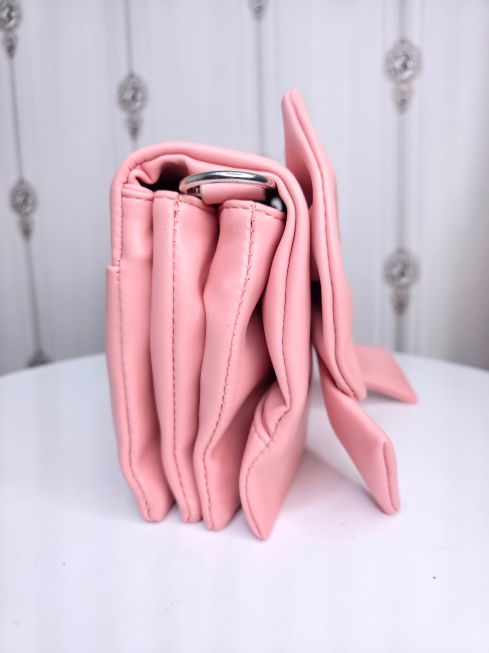 Soft leather peach bow bag with detachable sling