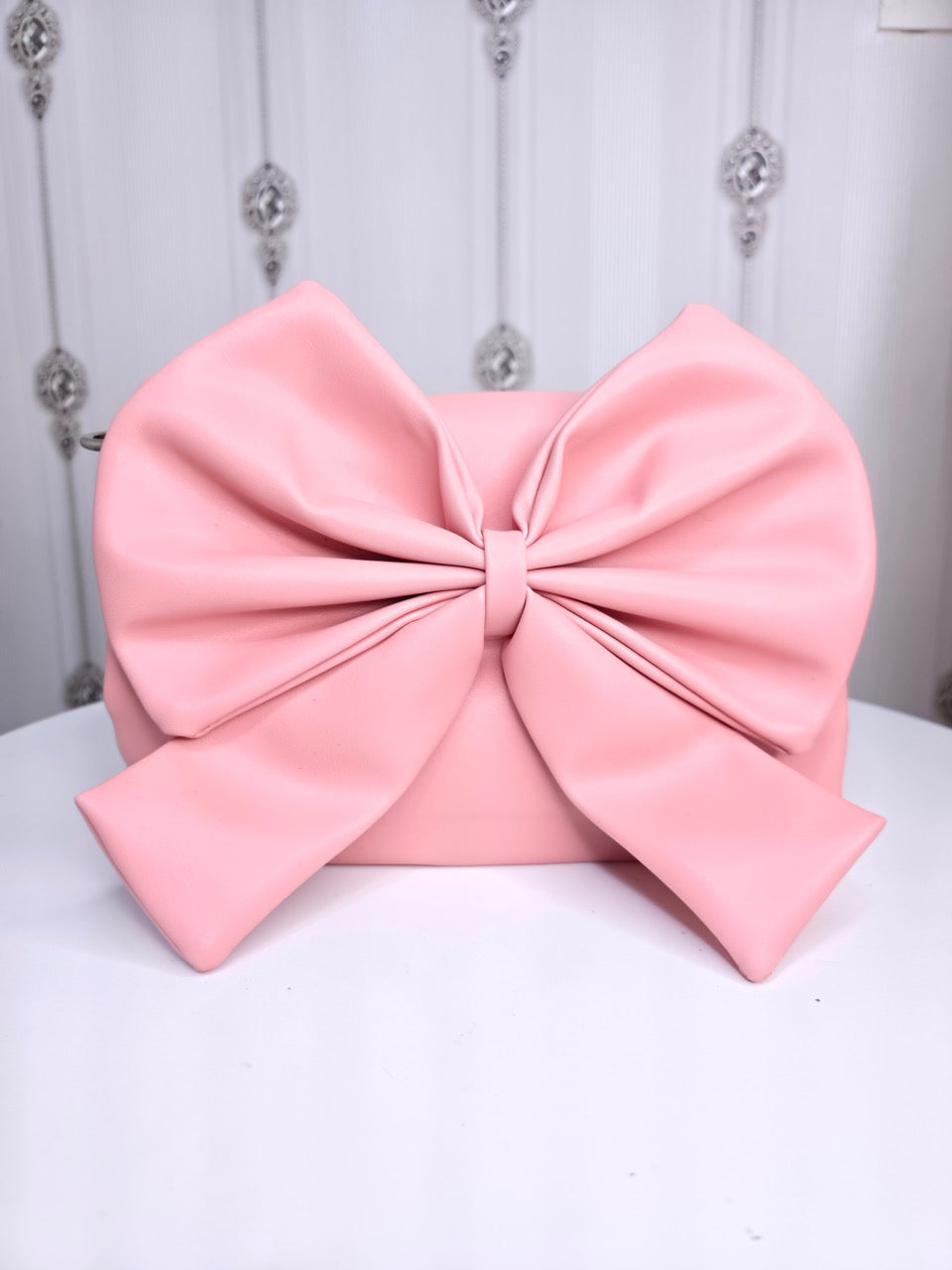 Soft leather peach bow bag with detachable sling