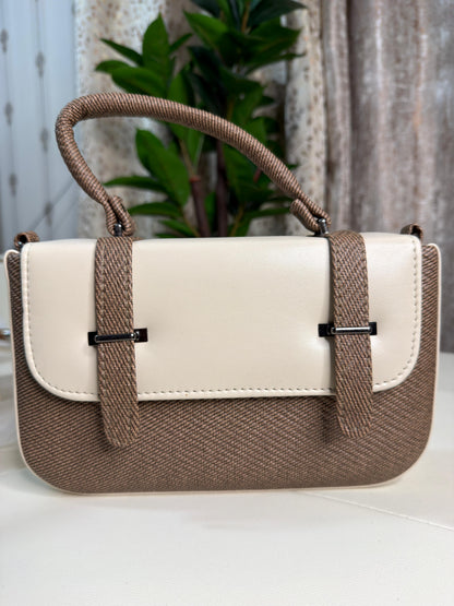 Handbag with beige and white design on a light background