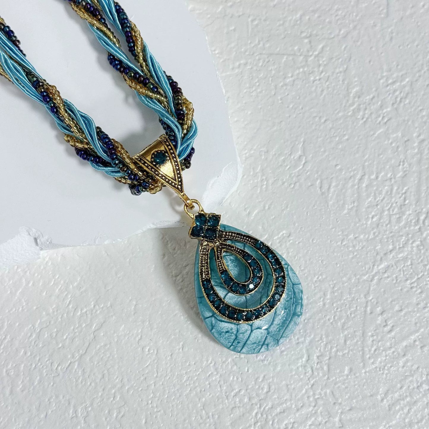 Multi-Strand Beaded Necklace with Ornate Teardrop Pendant