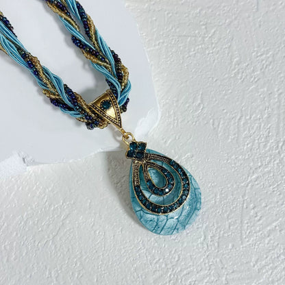 Multi-Strand Beaded Necklace with Ornate Teardrop Pendant