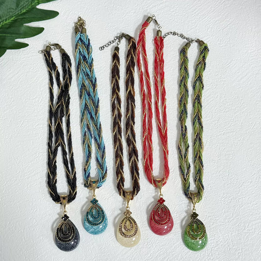 Multi-Strand Beaded Necklace with Ornate Teardrop Pendant