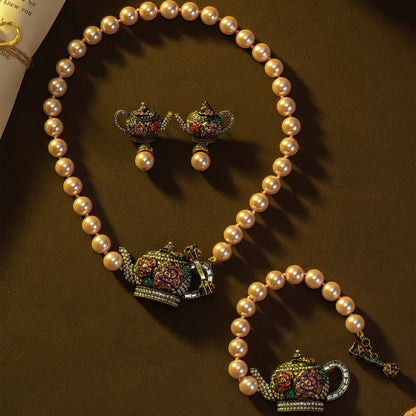 Pearl necklace with teapot-shaped pendants on a brown background