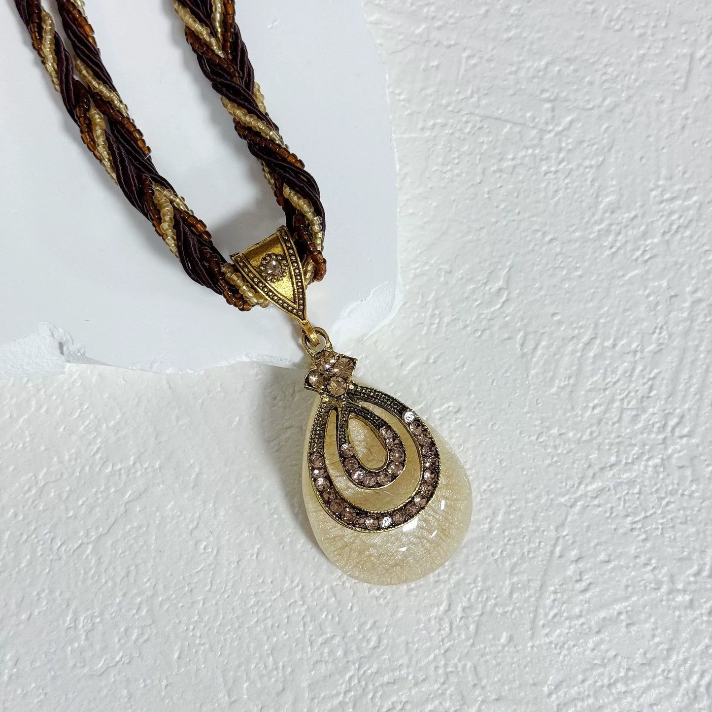 Multi-Strand Beaded Necklace with Ornate Teardrop Pendant