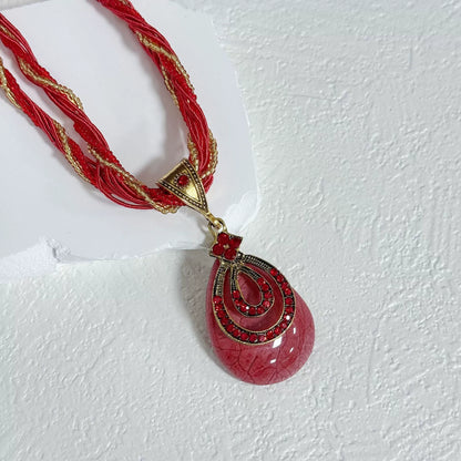 Multi-Strand Beaded Necklace with Ornate Teardrop Pendant