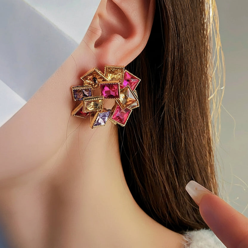 Multicolored geometric earring worn by a person, with 'WM ACC' branding.